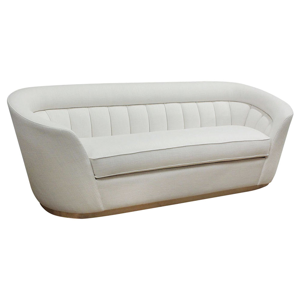 curved modern sofa with brass base and back scalloped upholstery