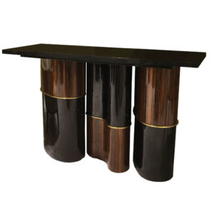 modern console entry table with sculptural base of macassar ebony and lacquer with brass accents and granite top