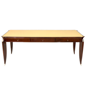 Art Deco desk designed by Jean Pascaud in brown mahogany wood and light leather top with nickel hardware and foot caps.