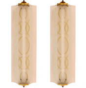 Art Deco elongated sconces with frosted glass and brass hardware.