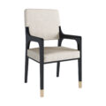 The Aspen dining chair with arms features a dark lacquer frame and smoked brass details.