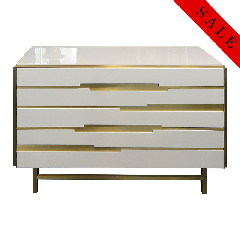 Modernistic dresser with white lacquer body with high gloss finish and smoked brass details.