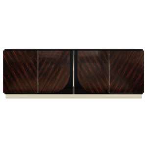 The Dylan Sideboard showcases a Macassar Ebony veneer in a high gloss finish with smoked Brass details.