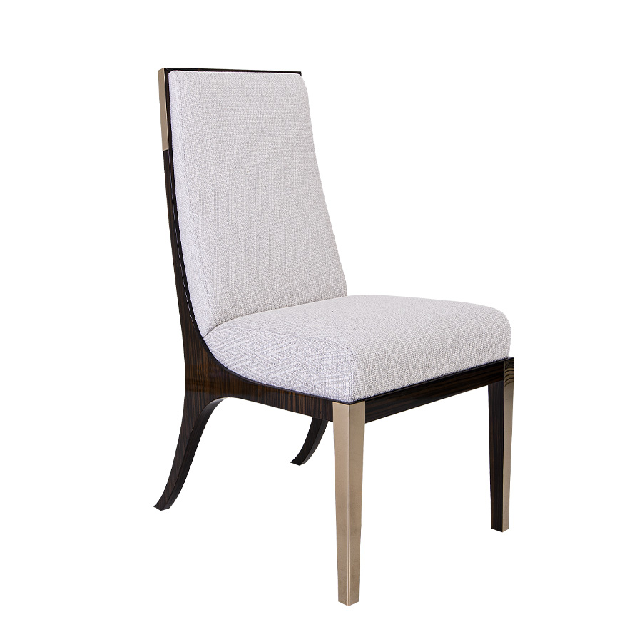 Dining chair with high gloss accents can brush brass legs.